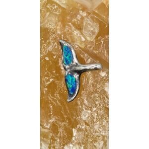 This is a charming whale tail-shaped pendant crafted from sterling silver.